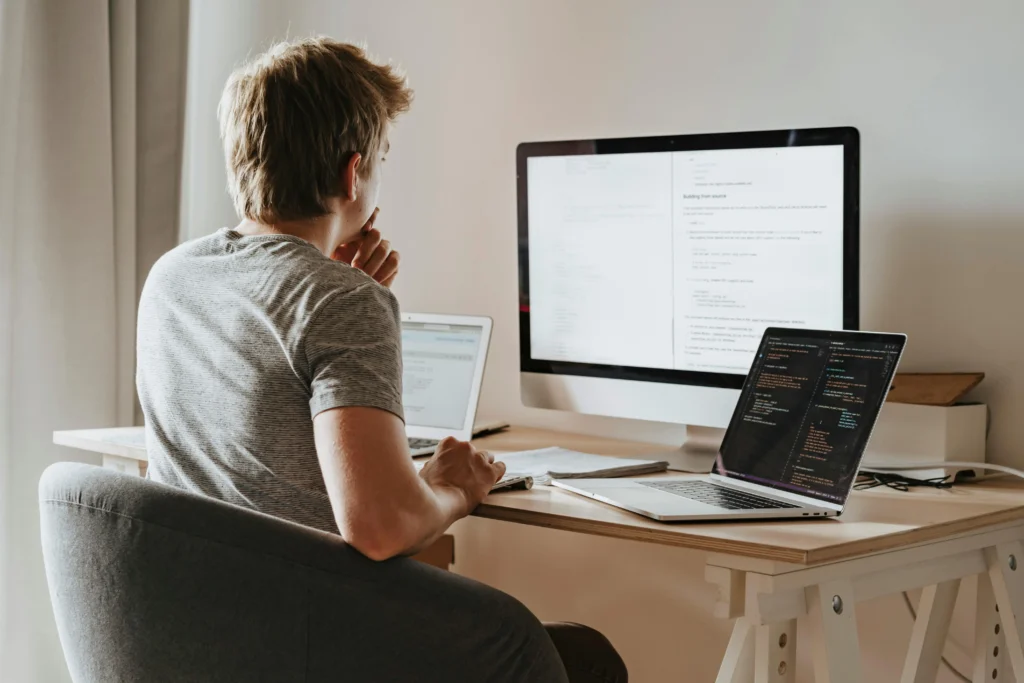 Man coding on his computer using VS Code