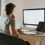 Man coding on his computer using VS Code