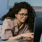 Person working remotely on a laptop in a home office setup representing remote tech jobs in 2025